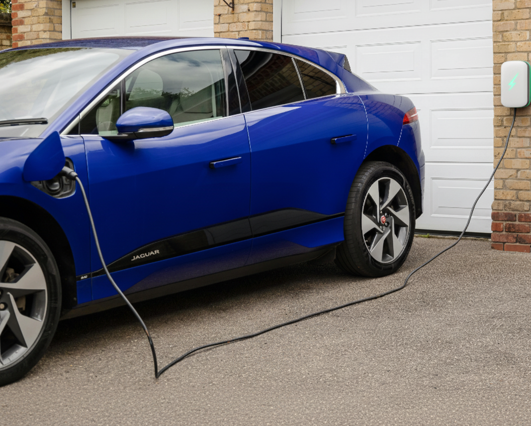 Home EV wall charger installed on a UK house exterior, illustrating the dominance of home charging.